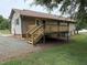 Exterior view of a wood deck with stairs leading down to the backyard at 1942 Brier Ln, Graham, NC 27253