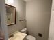 Neutral bathroom with white toilet, sink, framed mirror, and shower in well-lit setting at 1942 Brier Ln, Graham, NC 27253