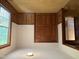 Bedroom with hardwood paneling, large window for natural light, providing a simple and comfortable atmosphere at 1942 Brier Ln, Graham, NC 27253