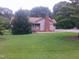 Charming single-story home featuring a brick chimney and a spacious front yard at 1942 Brier Ln, Graham, NC 27253