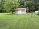 Well-kept outbuilding in lush green yard, perfect for storage and creative hobbies at 1942 Brier Ln, Graham, NC 27253