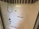 Shower-tub combo with floral wallpaper at 1942 Brier Ln, Graham, NC 27253