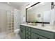 Bathroom featuring a double vanity, glass block shower, and ample counter space at 20 Wood Ibis Way, Louisburg, NC 27549