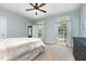 Bedroom with comfortable bed, ceiling fan, carpet, exterior access and natural light at 20 Wood Ibis Way, Louisburg, NC 27549