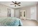 Comfortable bedroom features a ceiling fan and ample closet space for storage at 20 Wood Ibis Way, Louisburg, NC 27549