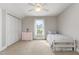 Bright bedroom with natural light features a cozy bed and ample closet space at 20 Wood Ibis Way, Louisburg, NC 27549