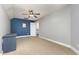 Large bonus room with blue accent wall and neutral walls and flooring at 20 Wood Ibis Way, Louisburg, NC 27549