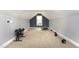 Spacious bonus room with a small window and workout equipment at 20 Wood Ibis Way, Louisburg, NC 27549