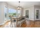 Bright dining room with a rustic wood table, bench seating, and backyard view at 20 Wood Ibis Way, Louisburg, NC 27549