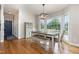 Bright dining room with hardwood floors, shiplap wall, and large windows at 20 Wood Ibis Way, Louisburg, NC 27549
