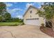 Garage exterior with driveway and well-manicured landscaping at 20 Wood Ibis Way, Louisburg, NC 27549