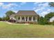 Beautiful one-story home with a covered front porch and well-maintained landscaping at 20 Wood Ibis Way, Louisburg, NC 27549
