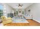 Bright living room with hardwood floors, large windows, and comfortable seating at 20 Wood Ibis Way, Louisburg, NC 27549