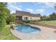 Backyard pool and deck with a view of the home's exterior at 20 Wood Ibis Way, Louisburg, NC 27549