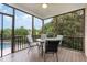 Screened-in porch with ceiling fan and seating with views of the backyard at 20 Wood Ibis Way, Louisburg, NC 27549