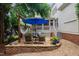 Elevated stone patio with outdoor seating, hammock, and lush landscaping, perfect for relaxing outdoors at 200 Cobblepoint Way, Holly Springs, NC 27540