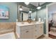 Bathroom features a double vanity sink with an ornate mirror and a soaking tub on the left at 200 Cobblepoint Way, Holly Springs, NC 27540