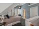 Cozy bedroom in neutral colors with built in shelves, dormer windows, and a ceiling fan at 200 Cobblepoint Way, Holly Springs, NC 27540