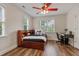 Cozy bedroom with wood floors, a bed, a desk, and natural light from the window at 200 Cobblepoint Way, Holly Springs, NC 27540