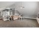 Open bonus room provides additional living space, with carpet and a ceiling fan at 200 Cobblepoint Way, Holly Springs, NC 27540