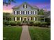 Charming two-story home with a covered front porch and well-manicured lawn at 200 Cobblepoint Way, Holly Springs, NC 27540