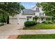Classic exterior with well-manicured lawn, attached garage, and covered front porch at 200 Cobblepoint Way, Holly Springs, NC 27540