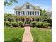 Inviting two-story home with a classic white facade, black shutters, and welcoming front porch at 200 Cobblepoint Way, Holly Springs, NC 27540