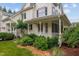Charming home featuring a welcoming front porch and professionally landscaped yard at 200 Cobblepoint Way, Holly Springs, NC 27540