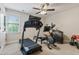 Home gym including a treadmill, an elliptical, and other exercise equipment at 200 Cobblepoint Way, Holly Springs, NC 27540