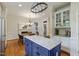 Bright kitchen with stainless steel appliances, blue island with granite countertops, and breakfast nook at 200 Cobblepoint Way, Holly Springs, NC 27540