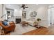 Cozy living room showcasing built-in shelving, a fireplace, and hardwood floors at 200 Cobblepoint Way, Holly Springs, NC 27540