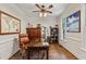 Well-appointed home office with hardwood floors, built-in shelving, and a large desk at 200 Cobblepoint Way, Holly Springs, NC 27540