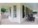 Covered porch with ample seating, views of the yard and plenty of natural light at 200 Cobblepoint Way, Holly Springs, NC 27540