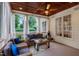 Cozy screened-in porch with comfortable seating, ceiling fan, and scenic outdoor views at 200 Cobblepoint Way, Holly Springs, NC 27540