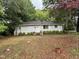 Charming single-story home with gray painted brick, trimmed hedges, and a welcoming front entrance at 200 Walnut St, Cary, NC 27511
