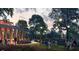 Outdoor event space with manicured lawn, mature trees, and modern pavilion for gatherings at 200 Walnut St, Cary, NC 27511