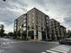 Contemporary urban apartment building featuring modern architectural design with prominent corner street signage at 200 Walnut St, Cary, NC 27511