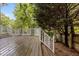 Well-maintained wooden deck with white railing, offering a pleasant outdoor living space and view of a private backyard at 2001 Dobson Ct, Raleigh, NC 27612