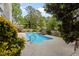 Picture of a beautifully landscaped backyard with a sparkling in-ground pool, waterfall feature and mature trees at 2001 Dobson Ct, Raleigh, NC 27612
