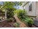 Lush backyard garden with a small walking path, mature plantings, and potted plants at 2001 Dobson Ct, Raleigh, NC 27612