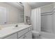 Clean bathroom with white cabinets, granite countertop, and a shower-tub combination at 2001 Dobson Ct, Raleigh, NC 27612