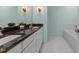 Bathroom featuring a granite countertop, double sinks, white cabinets, and tiled floors at 2001 Dobson Ct, Raleigh, NC 27612