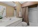 Well-lit bathroom features a white vanity, framed mirror, and shower-tub combo with tile surround at 2001 Dobson Ct, Raleigh, NC 27612