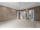 Bedroom featuring neutral carpet, tray ceiling, and access to ensuite bathroom and closet at 2001 Dobson Ct, Raleigh, NC 27612