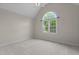 Spacious bedroom with a large arched window bringing in ample natural light at 2001 Dobson Ct, Raleigh, NC 27612