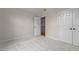 A bright, empty bedroom with neutral walls, plush carpeting, and two closets, perfect for customization at 2001 Dobson Ct, Raleigh, NC 27612