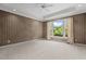 Bedroom featuring neutral carpet, a window with natural light, and tray ceiling at 2001 Dobson Ct, Raleigh, NC 27612