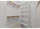 Walk-in closet with shelving and wood rods for hanging clothes at 2001 Dobson Ct, Raleigh, NC 27612