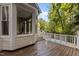 Covered porch showcases exterior deck with white railings, perfect for enjoying the outdoors at 2001 Dobson Ct, Raleigh, NC 27612