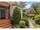 Charming front entrance with brick steps, black railing, and manicured landscaping at 2001 Dobson Ct, Raleigh, NC 27612